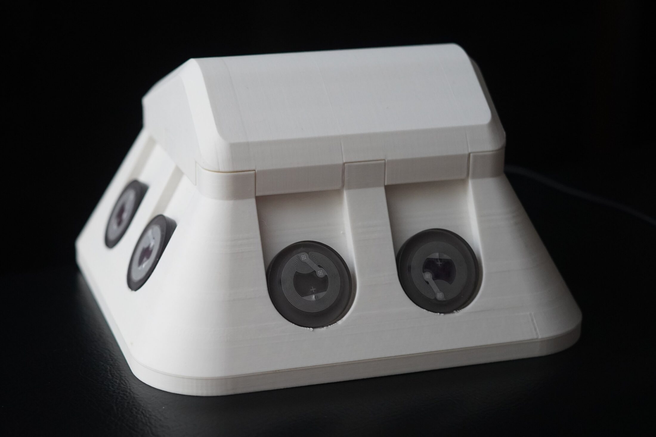 Three-quarter view of Teleflora showing four NFC token slots across two sides