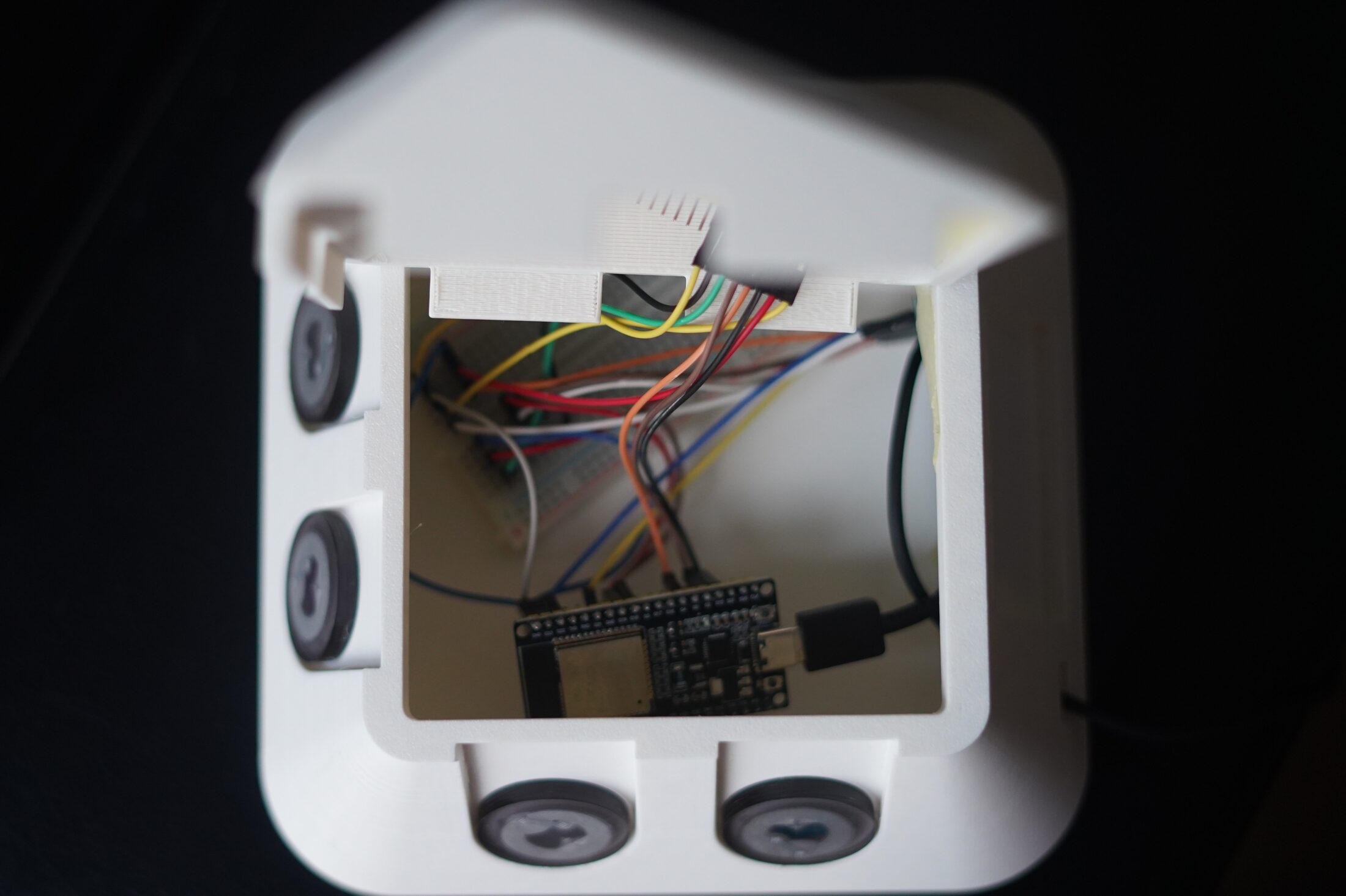Interior view of Teleflora through the service window showing ESP32 and wired breadboard