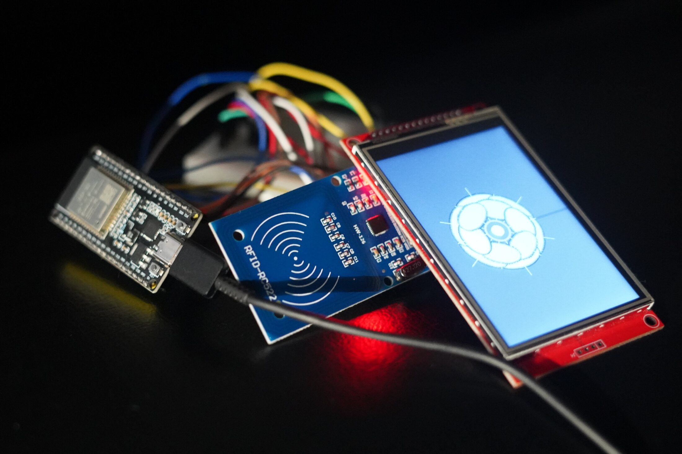 ESP32 paired with RFID-RC522 reader and TFT display rendering a stylised flower on tap
