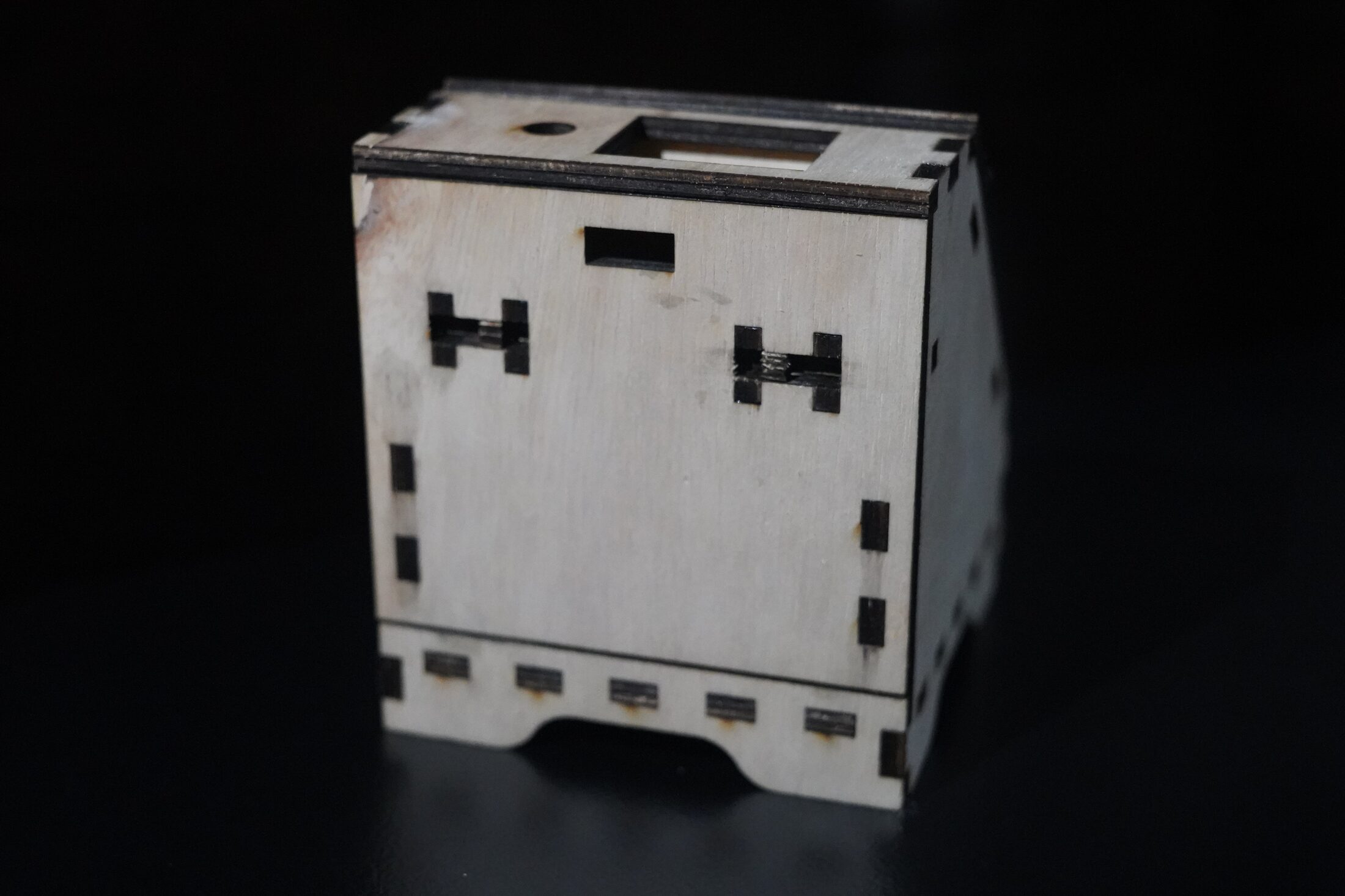 Laser-cut wooden cube enclosure with interlocking joints